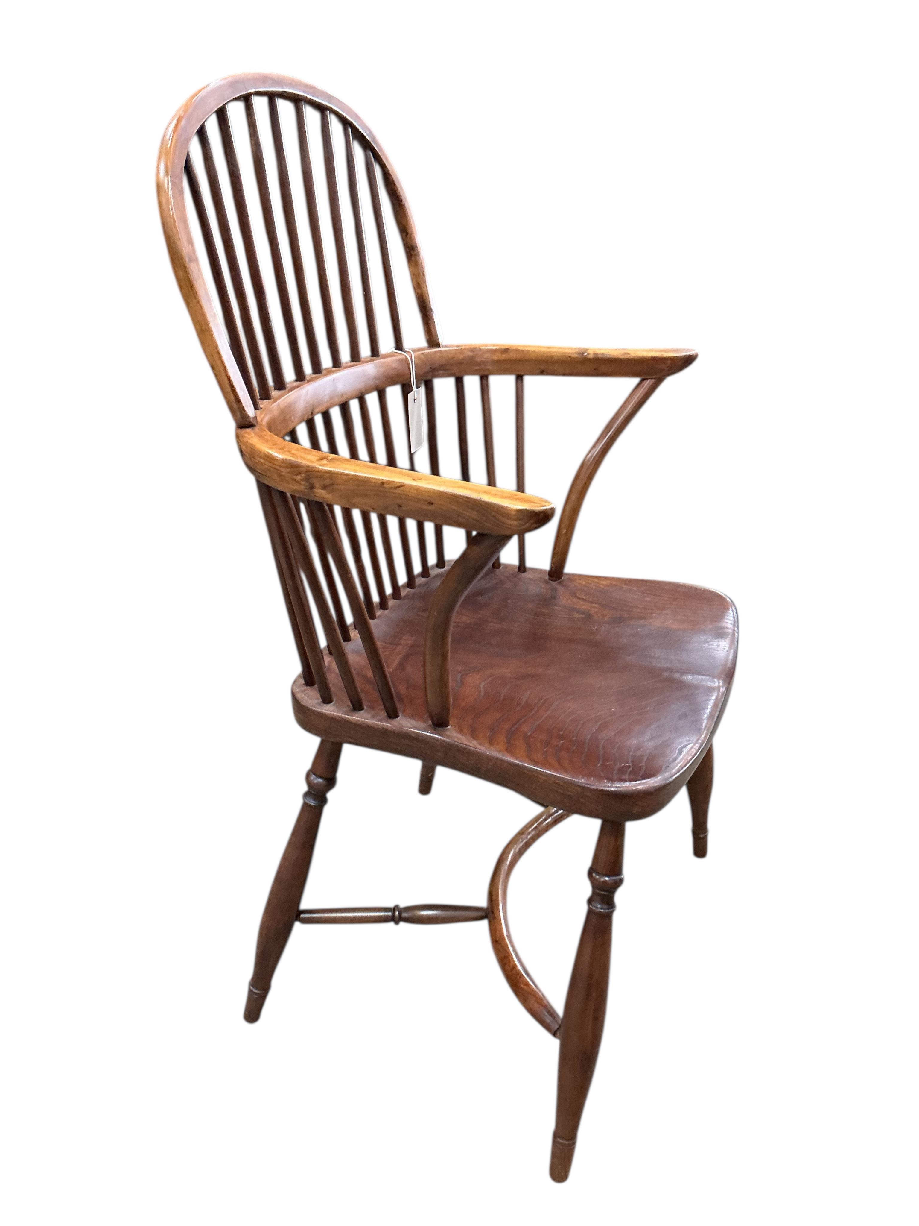 A yew and elm Windsor comb back elbow chair with crinoline stretcher, width 59cm, depth 42cm, height 96cm